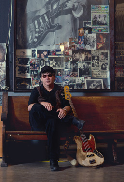 Tommy Shannon holding guitar